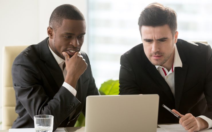 business men looking at computer screen