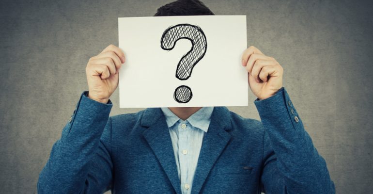 man holding paper with question mark