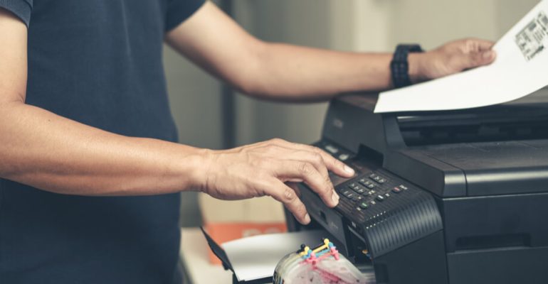 Man using printer in office