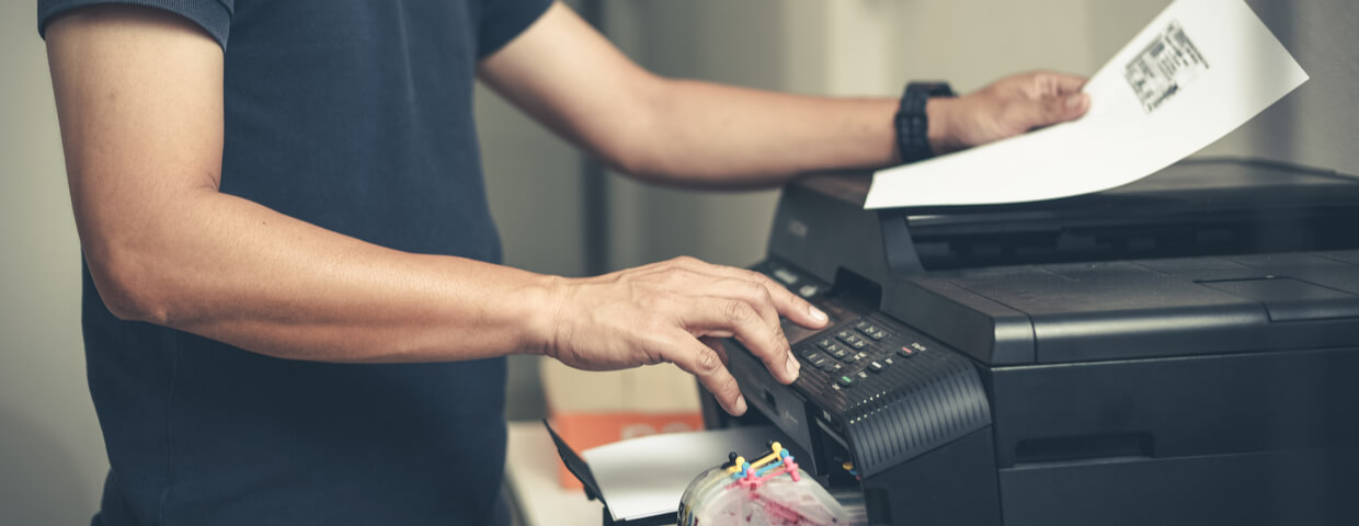 http://Man%20using%20printer%20in%20office