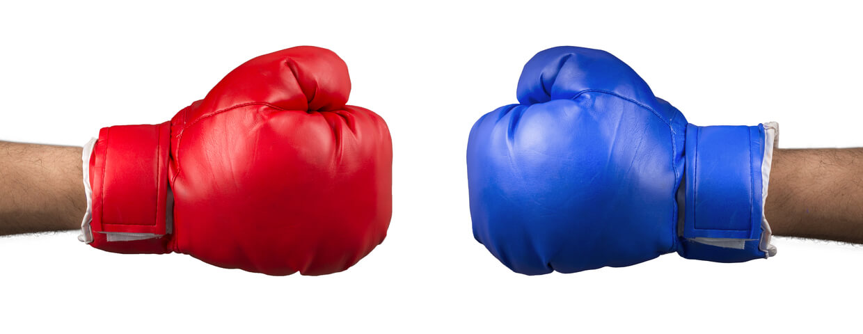 http://Red%20boxing%20glove%20and%20blue%20boxing%20glove%20on%20opposite%20sides%20of%20each%20other