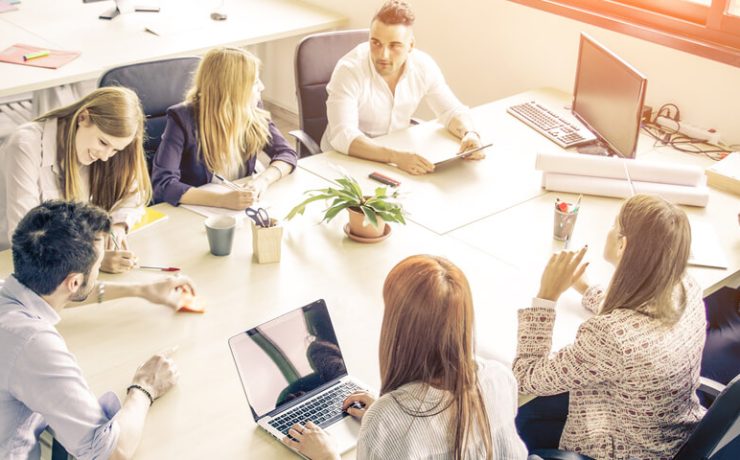 Group of people sitting at table having a meeting