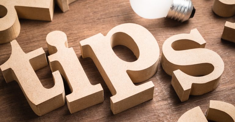 Wooden letters that spell out the word tips with a lightbulb above them