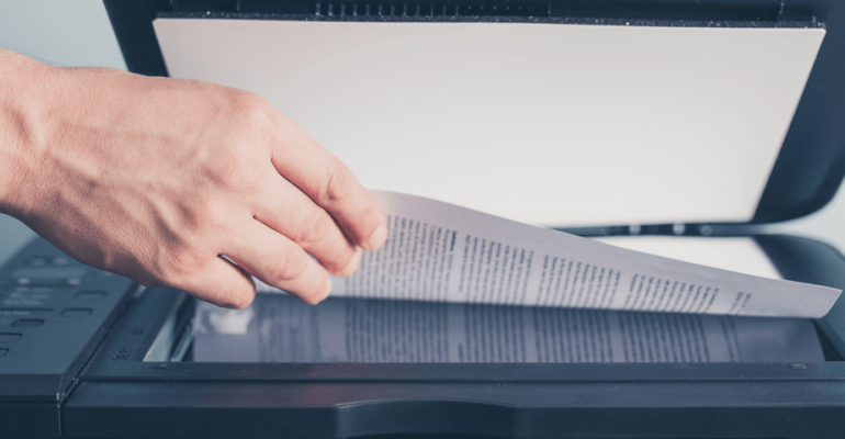 Business man scanning paper