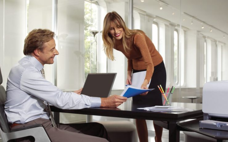 Two business people working together and smiling
