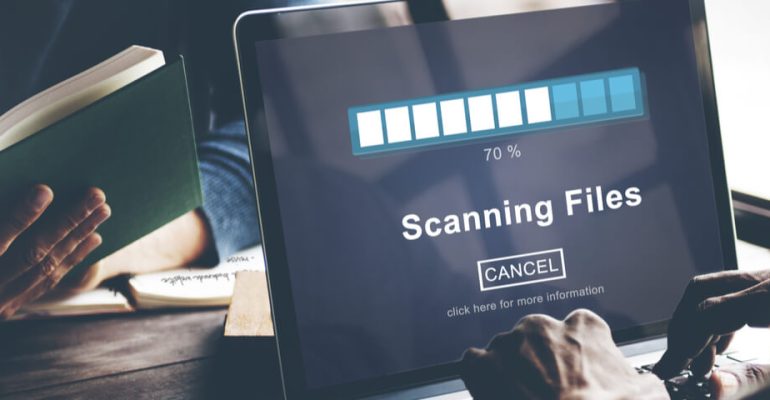 Close up of machine that has the words scanning files on the display with a progress bar