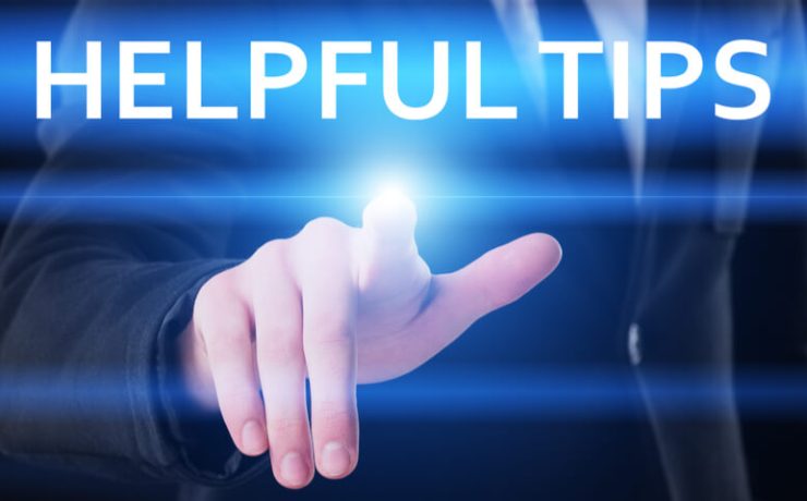 Man in suit placing finger on virtual display that reads helpful tips