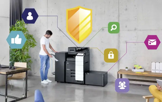 Man using a multi-function printer in an office with colorful security icons designating different security features
