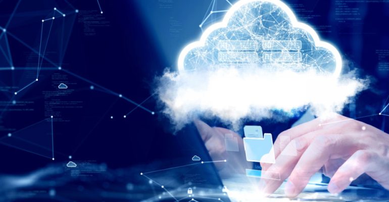 Hands typing on a laptop keyboard with a cloud floating over them