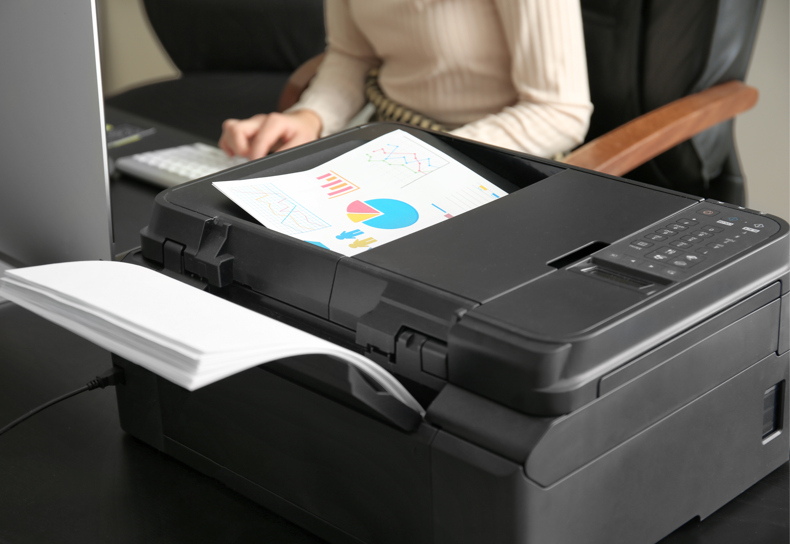 Office employee using a printer as part of a managed print services program