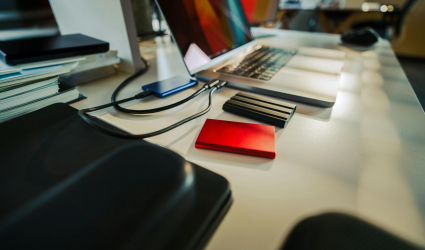 Computers plugged into storage devices referencing backup and disaster recovery.
