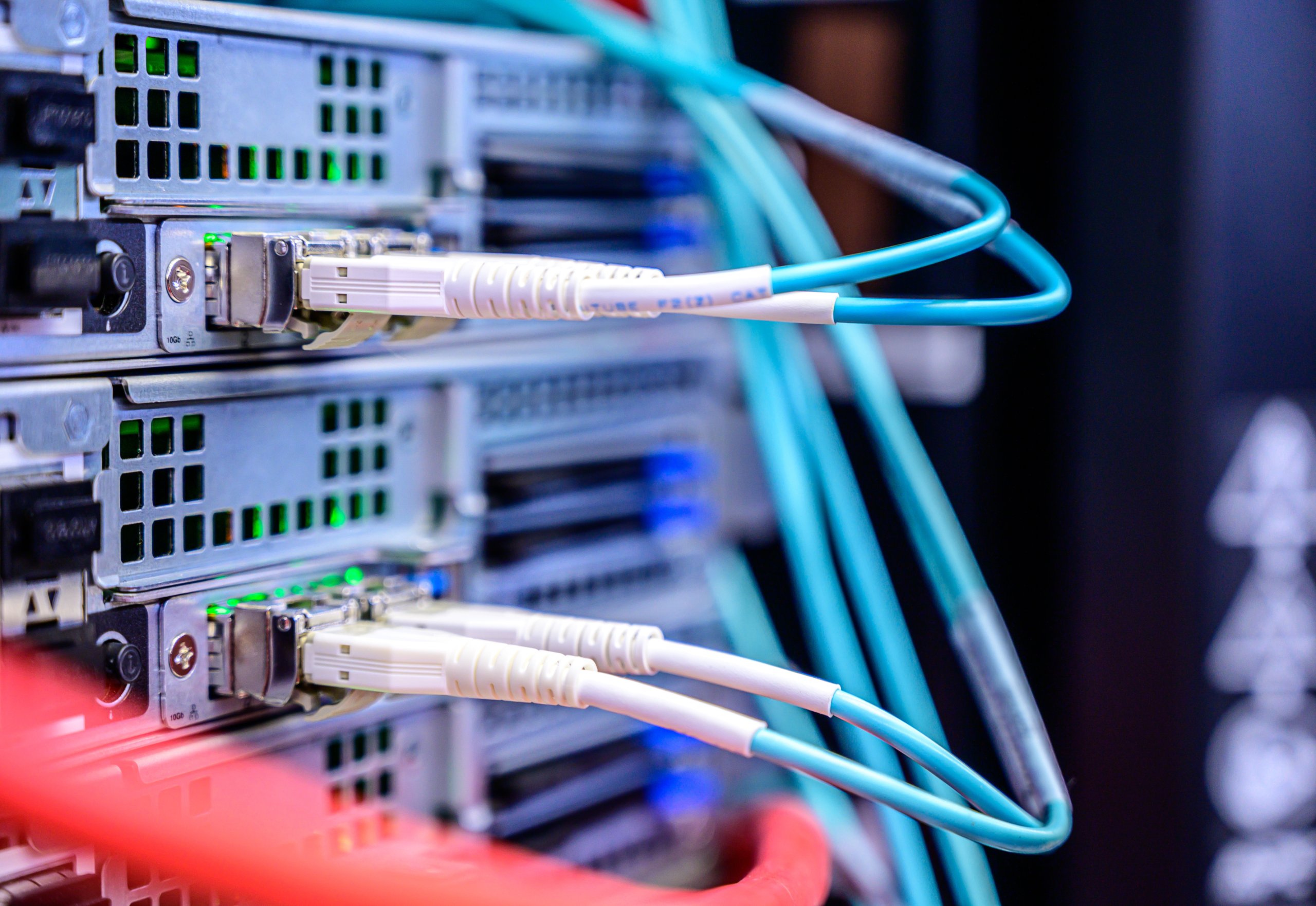 Backside of a server box showing wires going in and out of network. Representing IT and security infrastructure