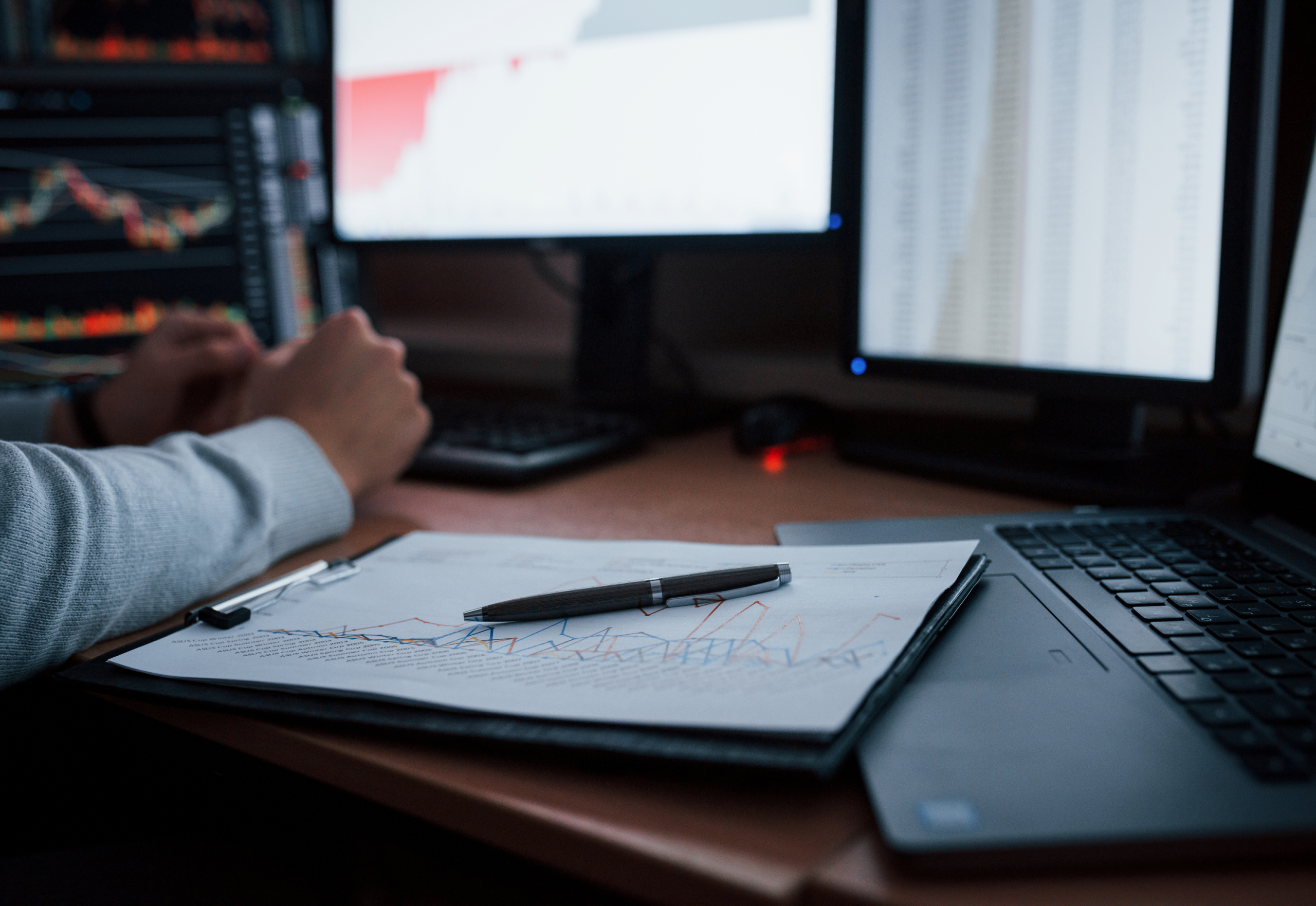 Multiple devices and paper and pen shown to represent remote monitoring