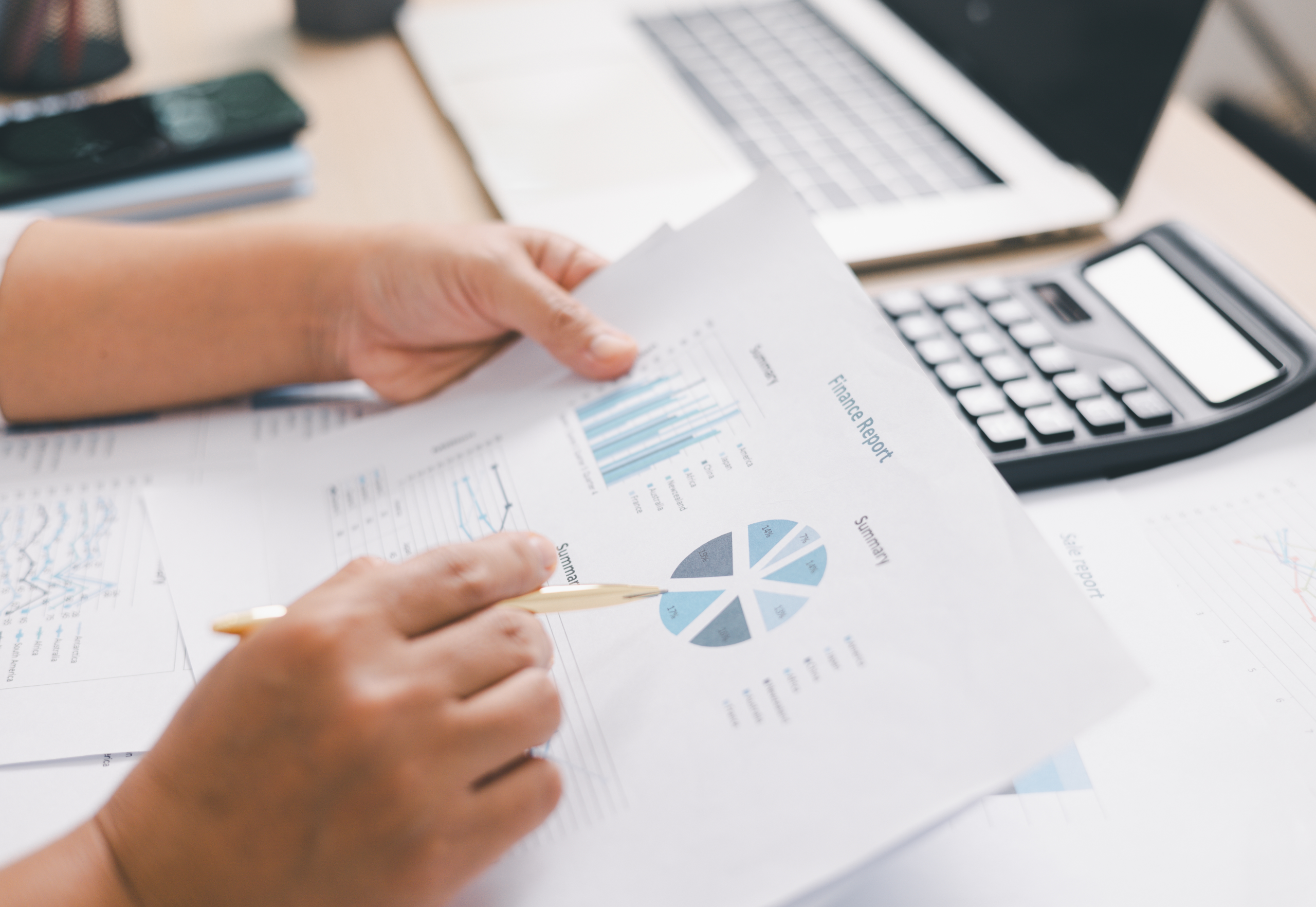 Employee reviewing reports and digital files in a document management system