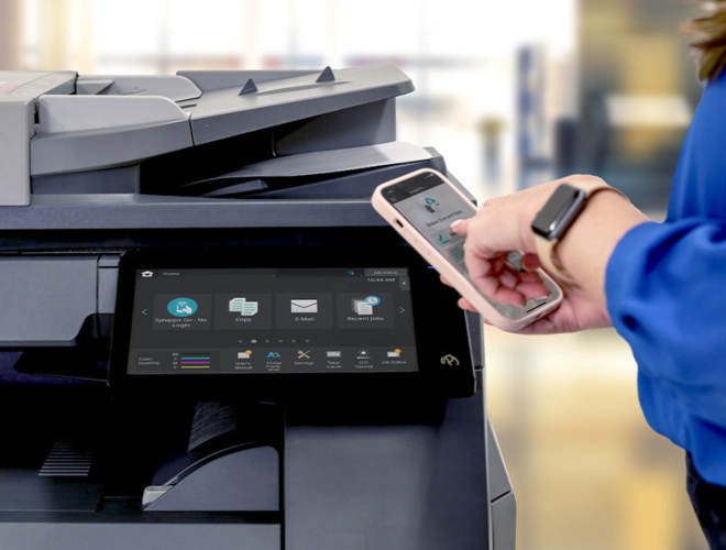 Person using a smartphone to connect and print from a multifunction printer.