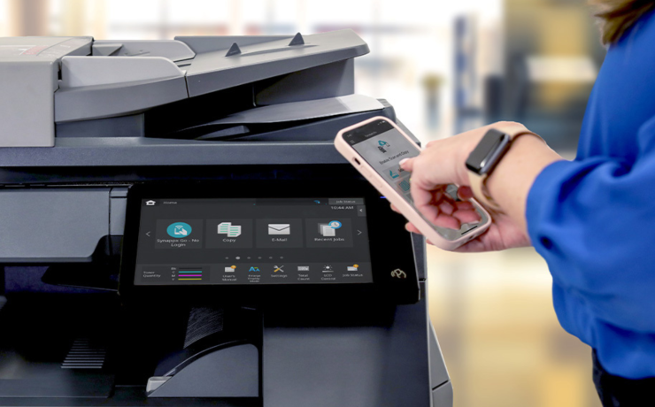 Person using a smartphone to connect and print from a multifunction printer.