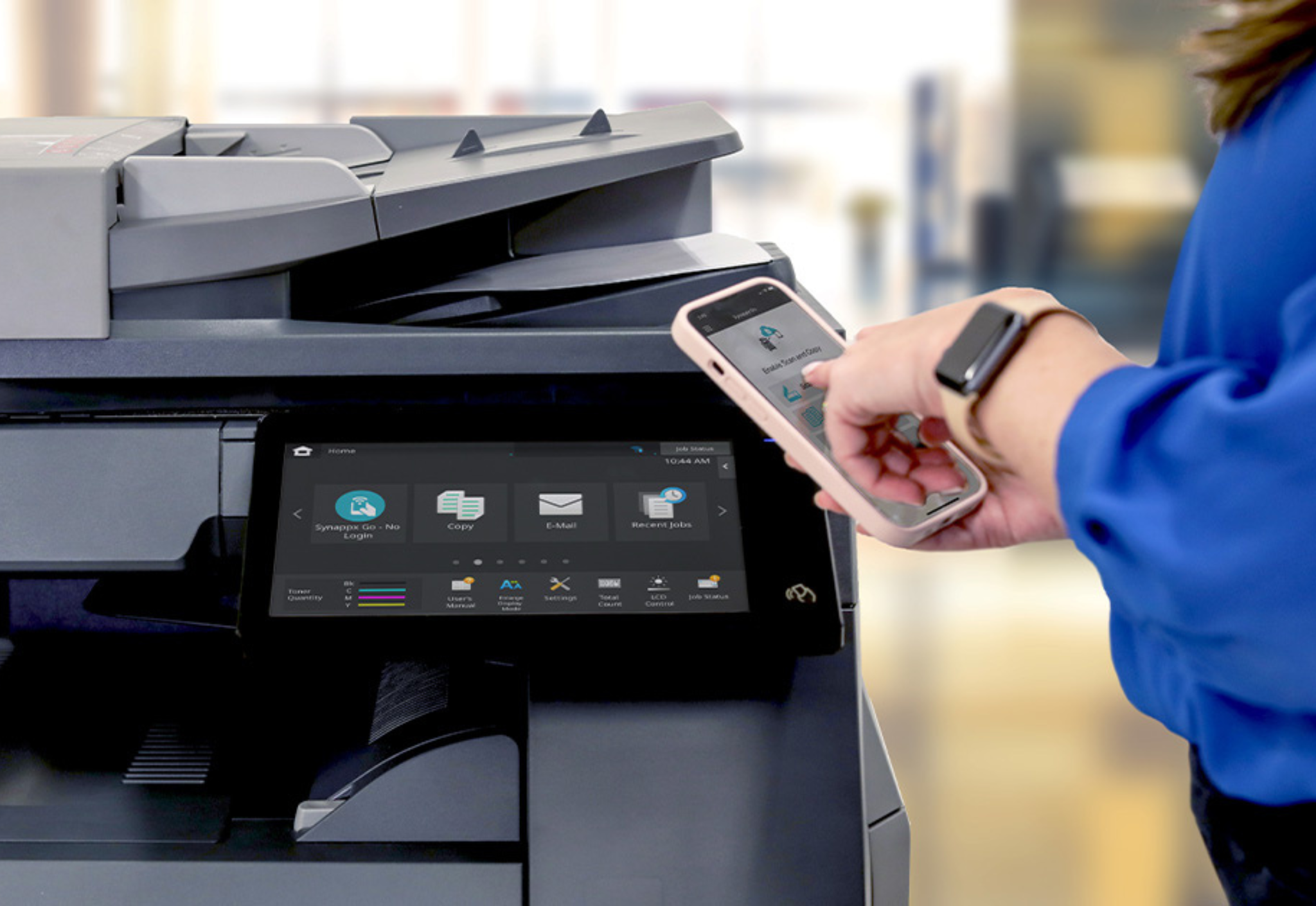 Person using phone to learn more about capabilities of Sharp print device.